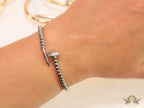 Platinum plated cz and metallic bead nail bracelet-openable