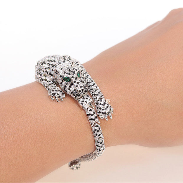 Cubic zirconia stone studded panther motif with emerald green colour stone details platinum plated bracelet