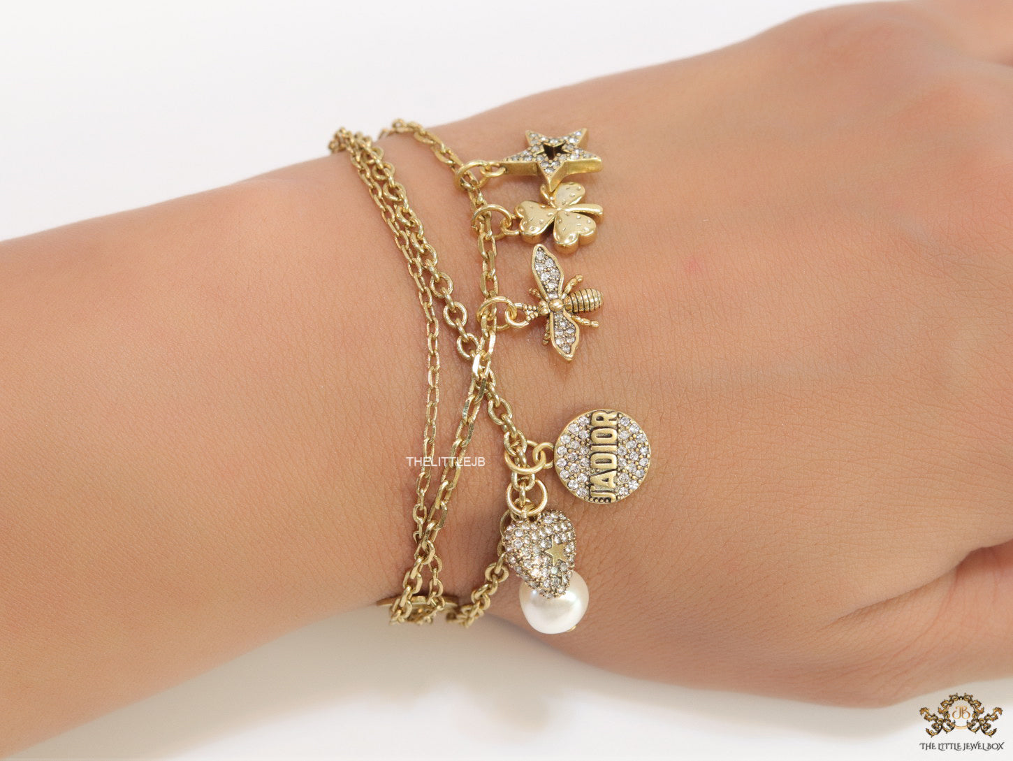 Multilayered gold plated chain bracelet with various cz charms