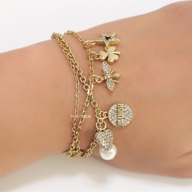 Multilayered gold plated chain bracelet with various cz charms