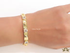 Band style bracelet in gold plating with gold plated details and cubic zirconia stones