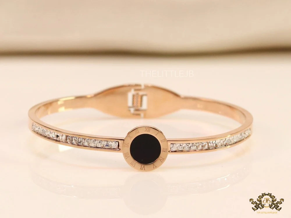 Rose gold plated cz bracelet with roman numerals inscribed on black centre motif