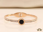 Rose gold plated cz bracelet with roman numerals inscribed on black centre motif