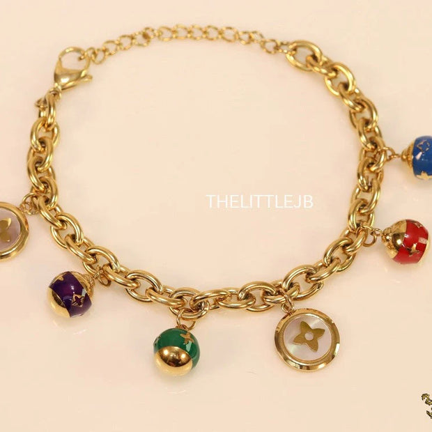 Gold plated link chain bracelet with multi enamel and MOP charms
