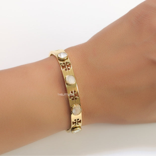 Gold plated cutwork twin T motif bracelet with white stones