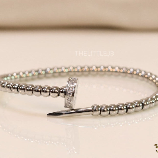 Platinum plated cz and metallic bead nail bracelet-openable