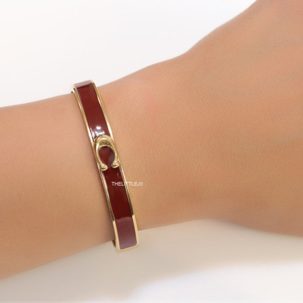 Sleek maroon and golden bracelet with C alphabet in centre