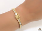 Gold plated bracelet with cz, inscribed alphabets and twin disc motif