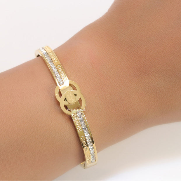 Gold plated bracelet with cz, inscribed alphabets and twin disc motif