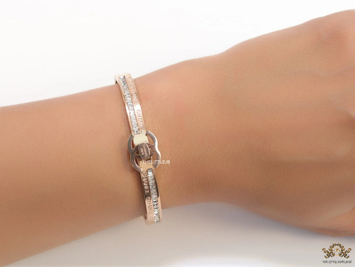 Rose gold plated bracelet with cz, inscribed alphabets and twin disc motif