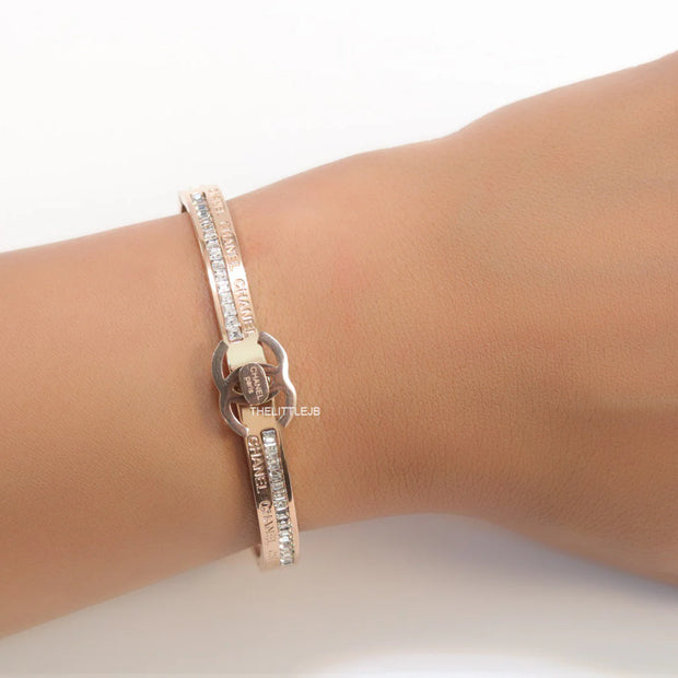 Rose gold plated bracelet with cz, inscribed alphabets and twin disc motif