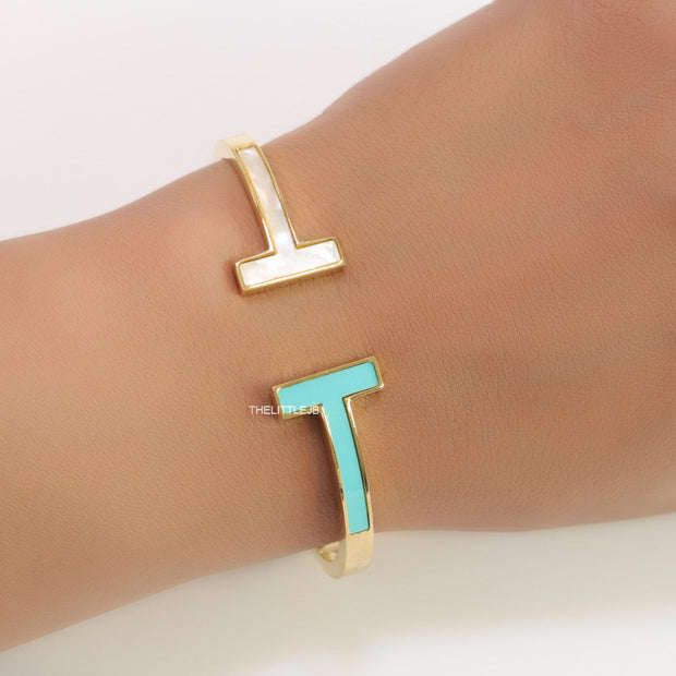 Gold plated open bracelet with blue enamel and MOP ends