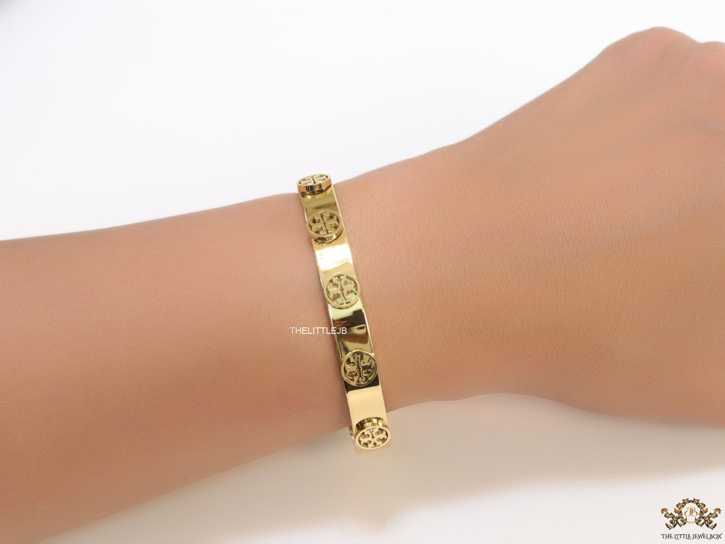 Gold plated bracelet with twin T motifs