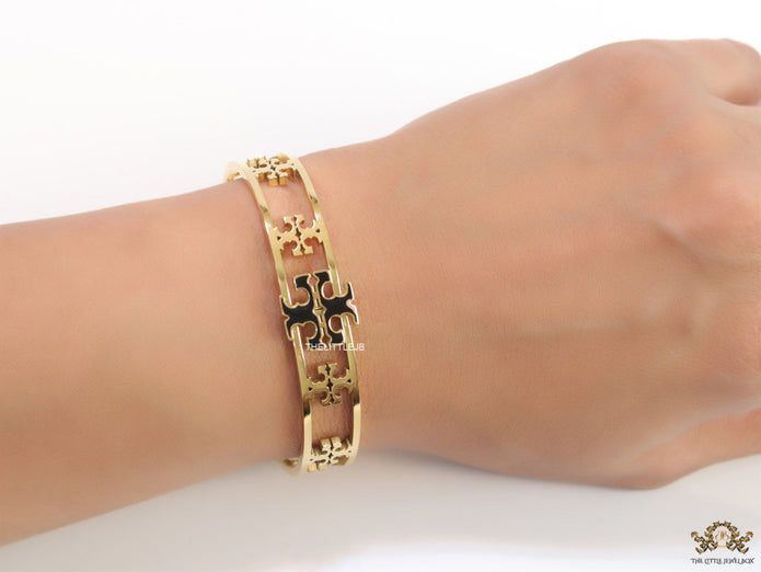 Gold plated openable bracelet with fancy cutwork T motifs