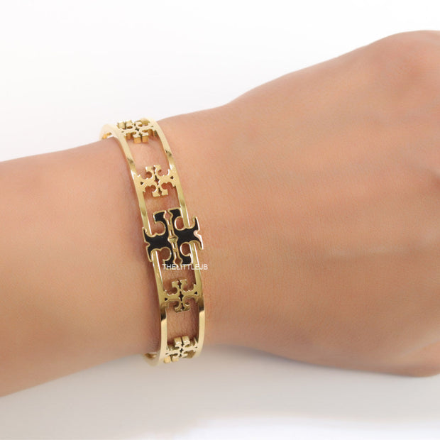 Gold plated openable bracelet with fancy cutwork T motifs