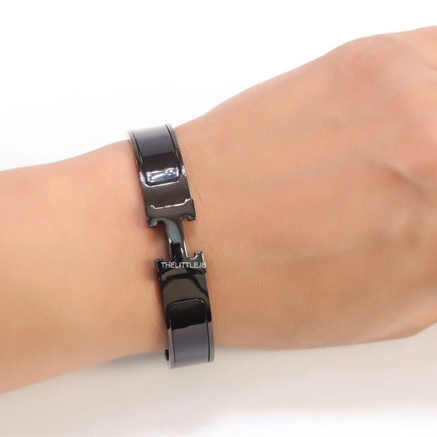 Broad black bracelet with H alphabet in centre