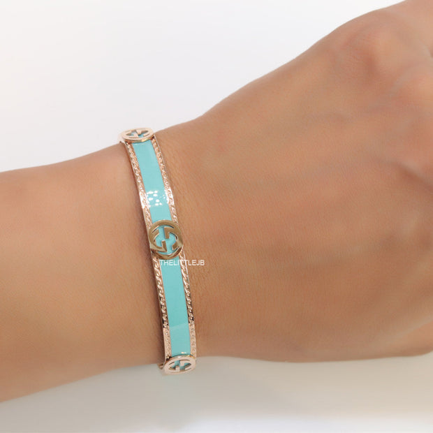 Blue and Rose gold open band bracelet with twin G alphabet motifs
