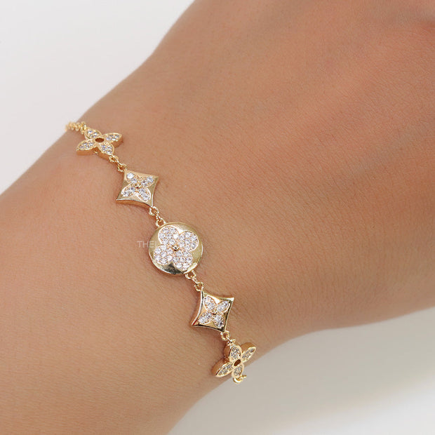 Gold plated chain bracelet with cz clovers and flowers
