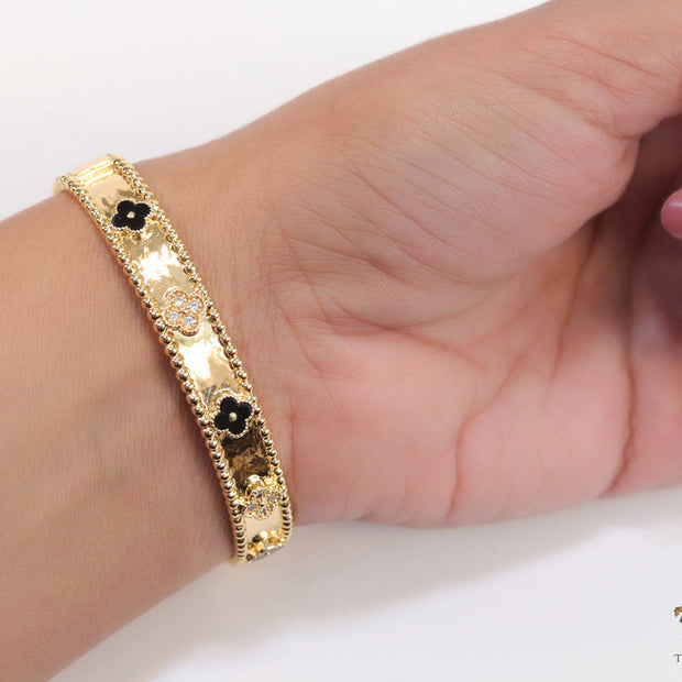Gold plated bracelet with clover motifs in cz and black enamel