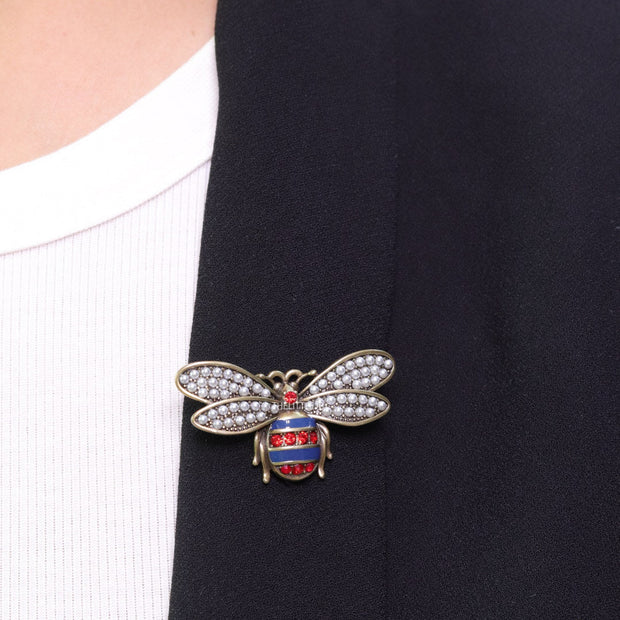 Antique gold finish bee brooch with white and red stones and blue details