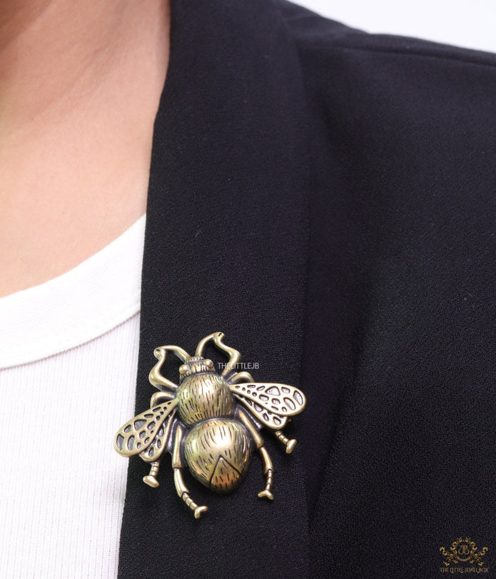Antique gold finish bee brooch with white and red stones and blue details
