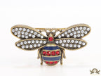 Antique gold finish bee brooch with white and red stones and blue details
