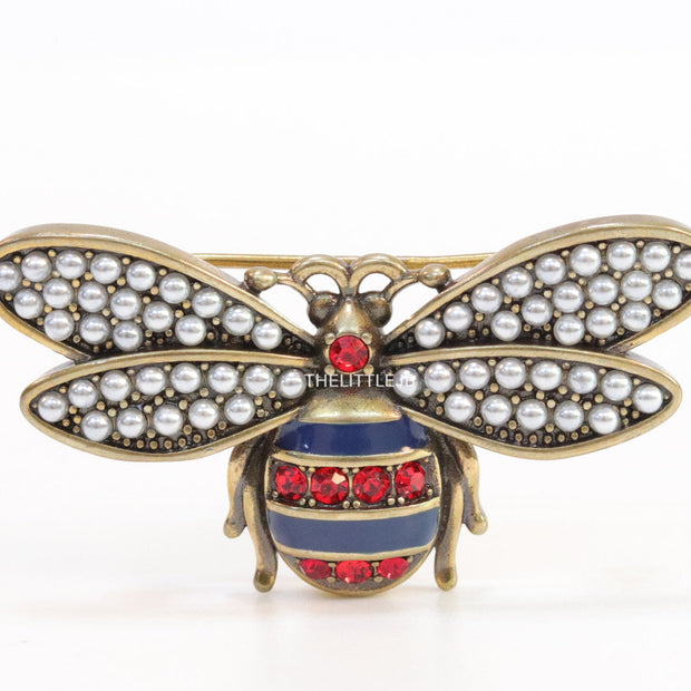 Antique gold finish bee brooch with white and red stones and blue details