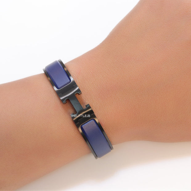 Premium collection band style bracelet in matt blue with black metallic details and black T alphabet motif