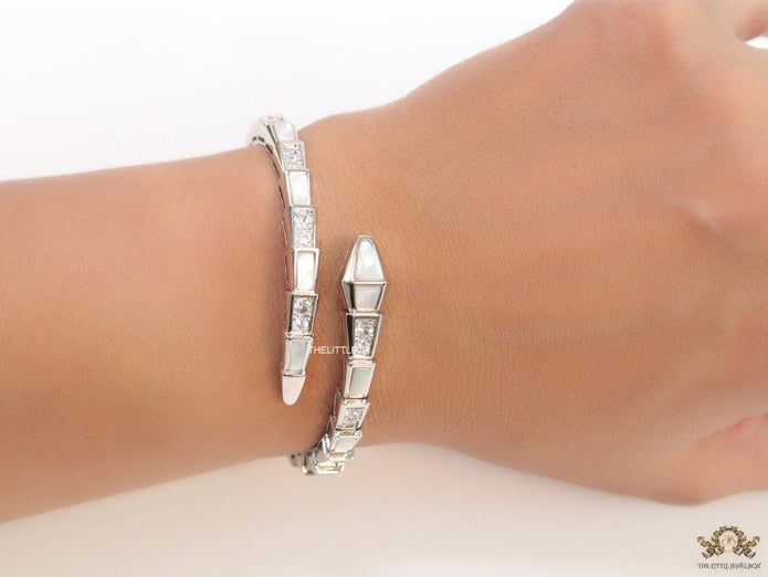 Open top platinum plated minimal snake bracelet with cubic zirconia stones and pearl white stones.