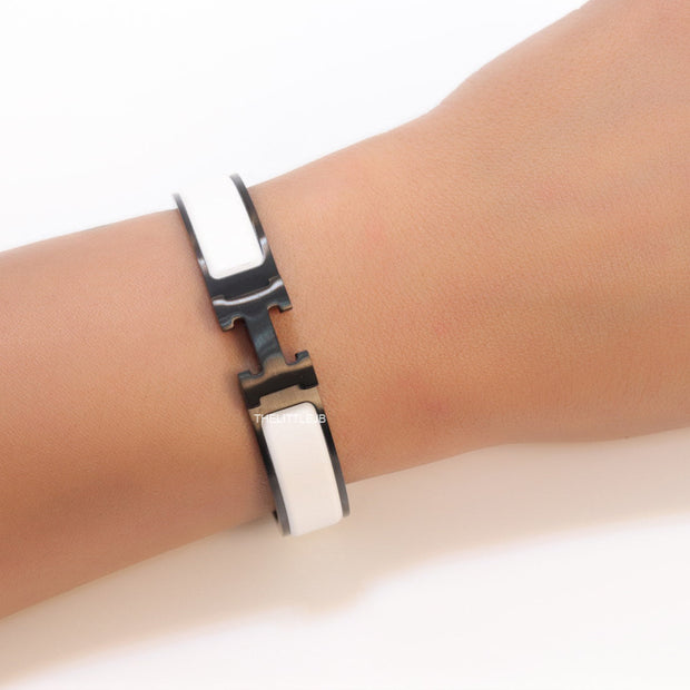 Premium collection band style bracelet in matt white with black metallic details and black T alphabet motif