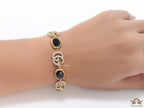 Gold plated linked chain bracelet with black stones and twin G alphabet motif