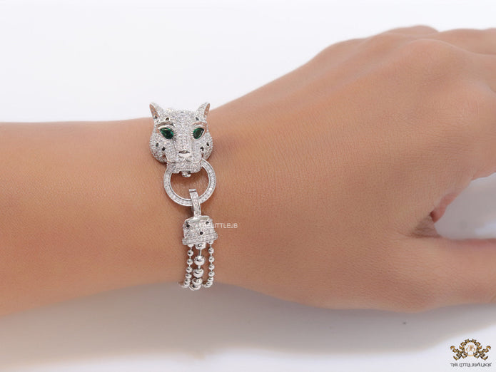 Platinum plated bracelet with cubic zirconia stones panther face motif with green cubic zirconia stone details and cubic zirconia stones disc