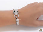 Platinum plated bracelet with cubic zirconia stones panther face motif with green cubic zirconia stone details and cubic zirconia stones disc