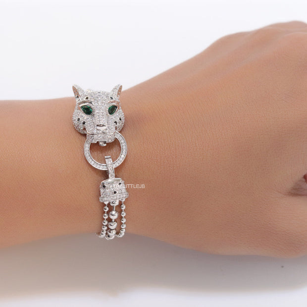 Platinum plated bracelet with cubic zirconia stones panther face motif with green cubic zirconia stone details and cubic zirconia stones disc