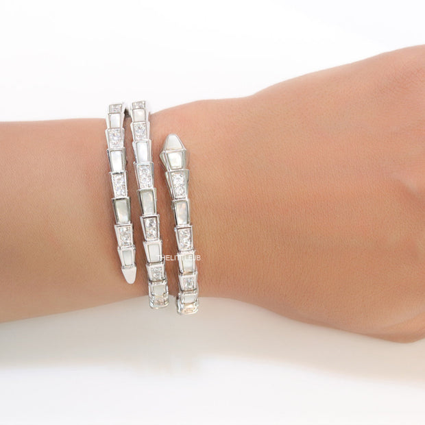 Triple line platinum plated minimal snake bracelet with cubic zirconia stones and pearl white stones.