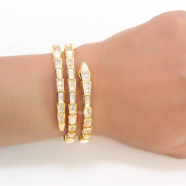 Triple line gold plated minimal snake bracelet with cubic zirconia stones and pearl white stones.