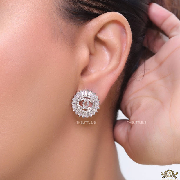 Round platinum studs lined with cz baguettes and twin C cz motif centre