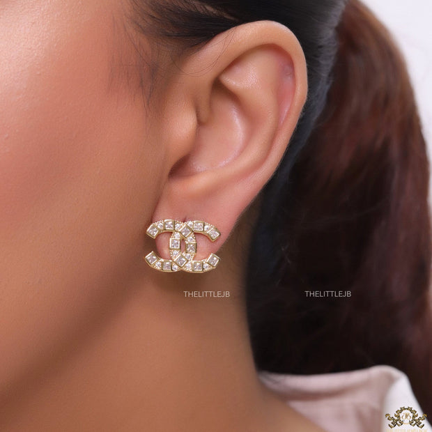Golden twin C motif studs with fancy cut cz