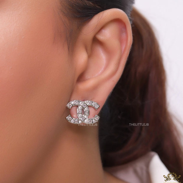 Platinum plated twin C motif studs with fancy cut cz
