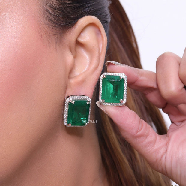 Platinum plated studs with emerald green doublet stone and white cubic zirconia stones lining