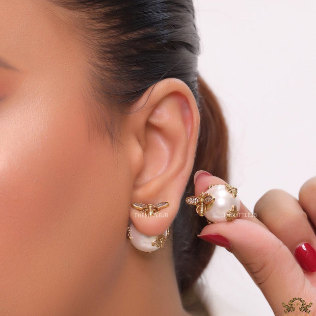 Designer pearl earrings with matte gold flying bee motifs