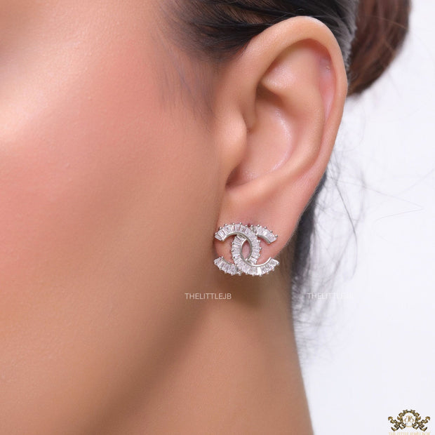 Platinum plated twin C motif studs in cz baguettes