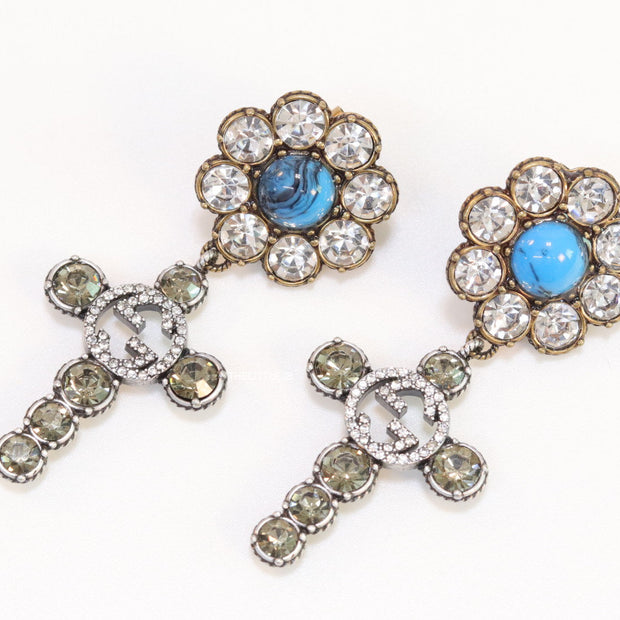 Floral cz and alphabet dangles with blue stone centre