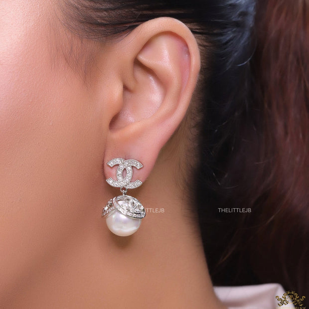 Platinum plated twin C earrings in cz with cz capped pearl drop