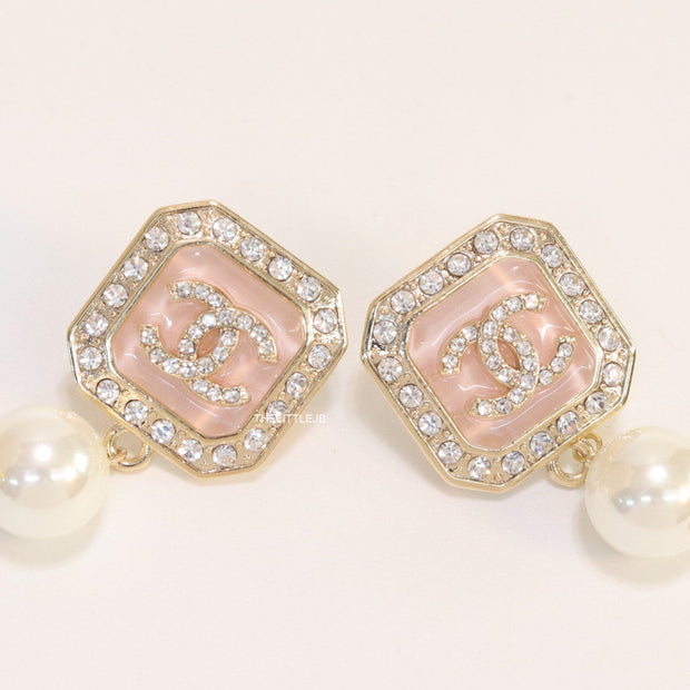 Light pink pearl drop earrings with twin C motif in cz