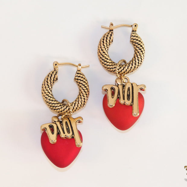 Golden hoops with alphabets and red pearl drop