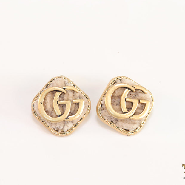 Cream velvet fur studs with golden twin G motif