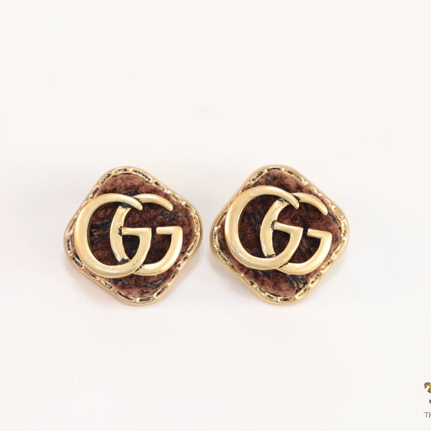 Brown velvet fur studs with golden twin G motif