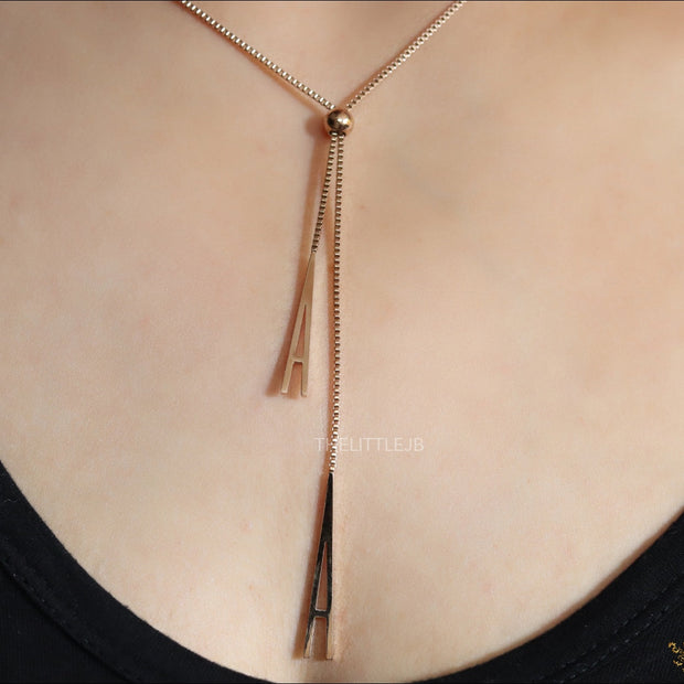 A initial sling necklace in gold finish
