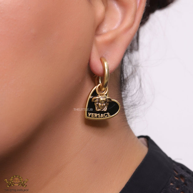 Golden and black enamel heart shape medusa earrings